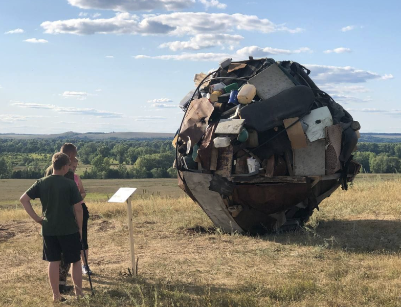 Visitors beside the Sisyphus installation